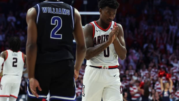Nov 19, 2023; Tucson, Arizona, USA; Arizona Wildcats guard Jaden Bradley (0) celebrates a basket against Texas-Arlington Mavericks guard Makaih Williams (2) during the second half at McKale Center.